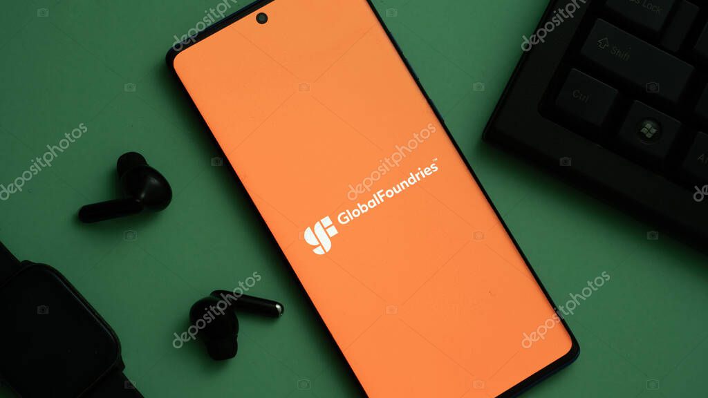 Dhaka, Bangladesh 04 May 2025: GlobalFoundries Inc. logo is seen on a mobile phone and a computer screen.