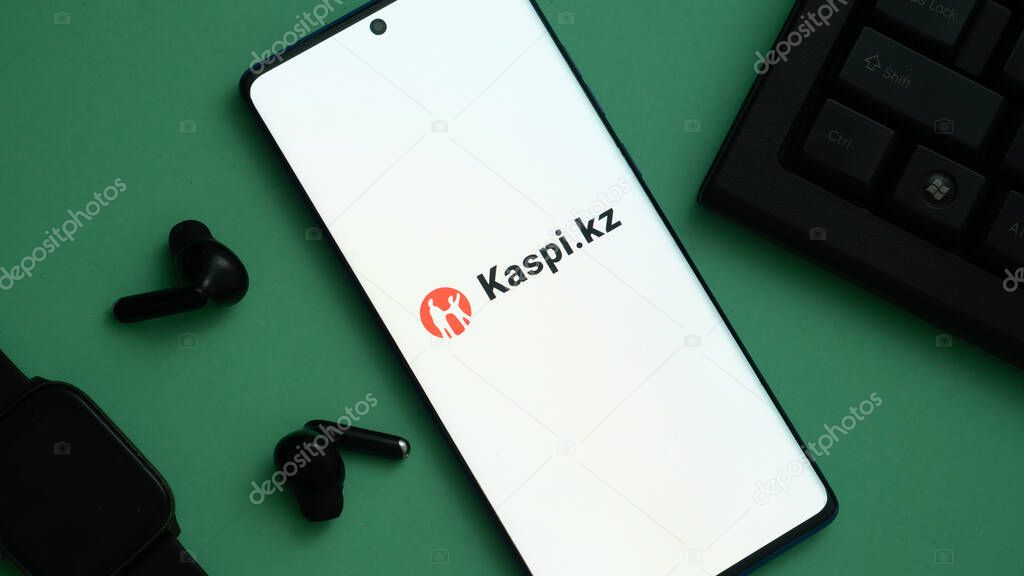 Dhaka, Bangladesh 04 May 2025: Mobile phone with logo of Kazakh financial services company Kaspi.kz in front of business website. Focus on center-left of phone display. Unmodified photo.