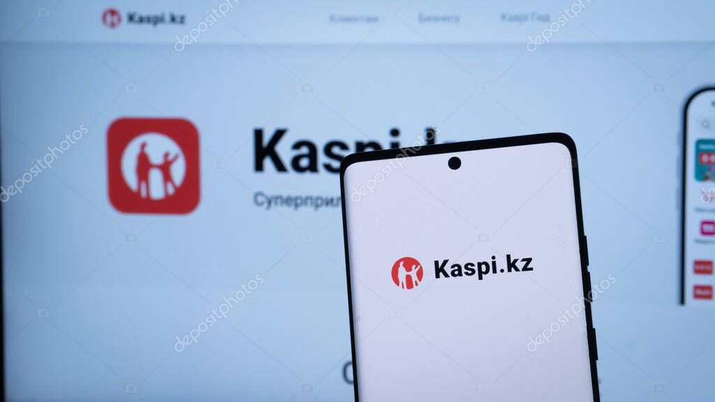 Dhaka, Bangladesh 04 May 2025: Mobile phone with logo of Kazakh financial services company Kaspi.kz in front of business website. Focus on center-left of phone display. Unmodified photo.