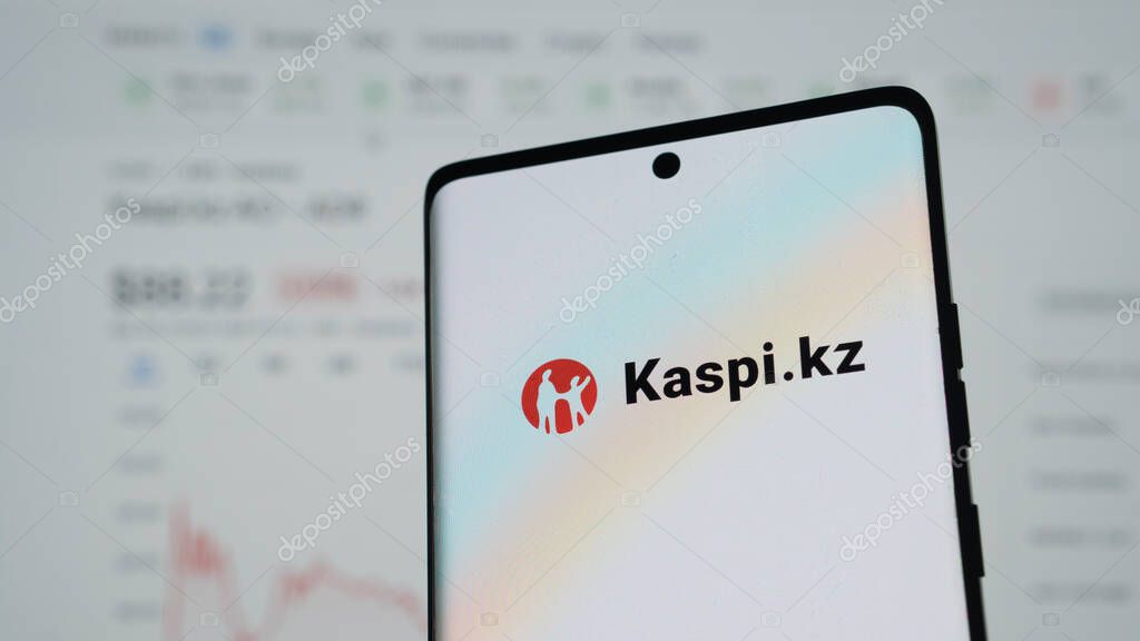 Dhaka, Bangladesh 04 May 2025: Mobile phone with logo of Kazakh financial services company Kaspi.kz in front of business website. Focus on center-left of phone display. Unmodified photo.
