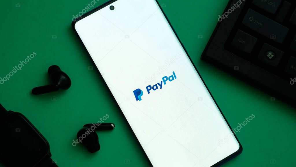 Dhaka, Bangladesh 04 May 2025: Smartphone on surface showing PayPal logo.