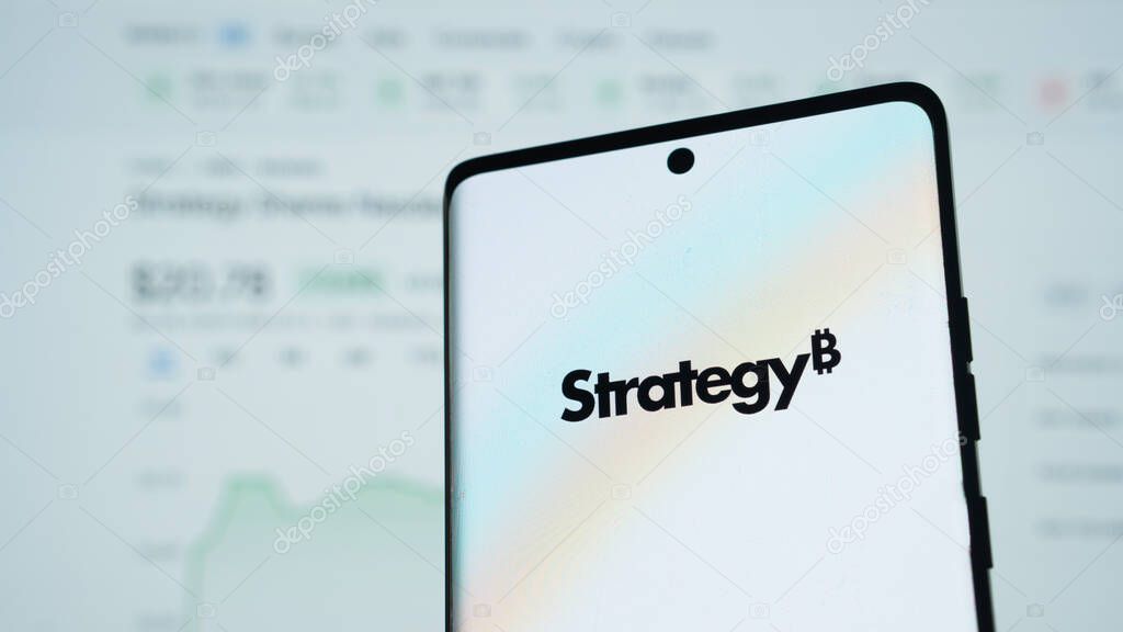 Dhaka, Bangladesh 24 May 2025:Smartphone features Strategy logo against a financial stock graph in the background.