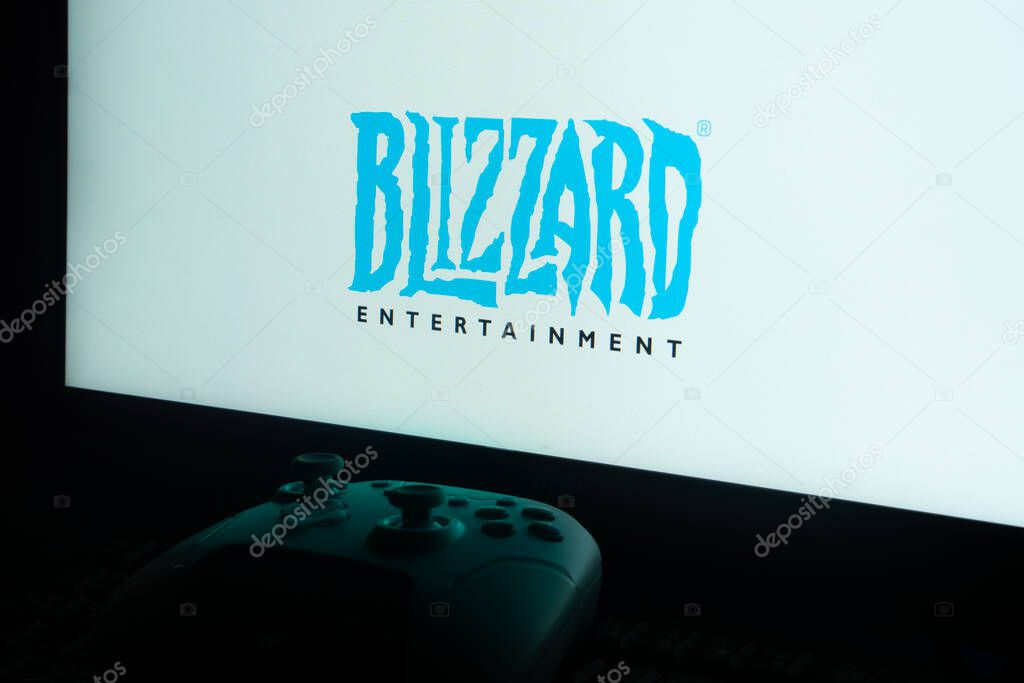 Dhaka, Bangladesh 02 June 2025:Monitor displaying BLIZZARD ENTERTAINMENT logo with a game controller in dim light.
