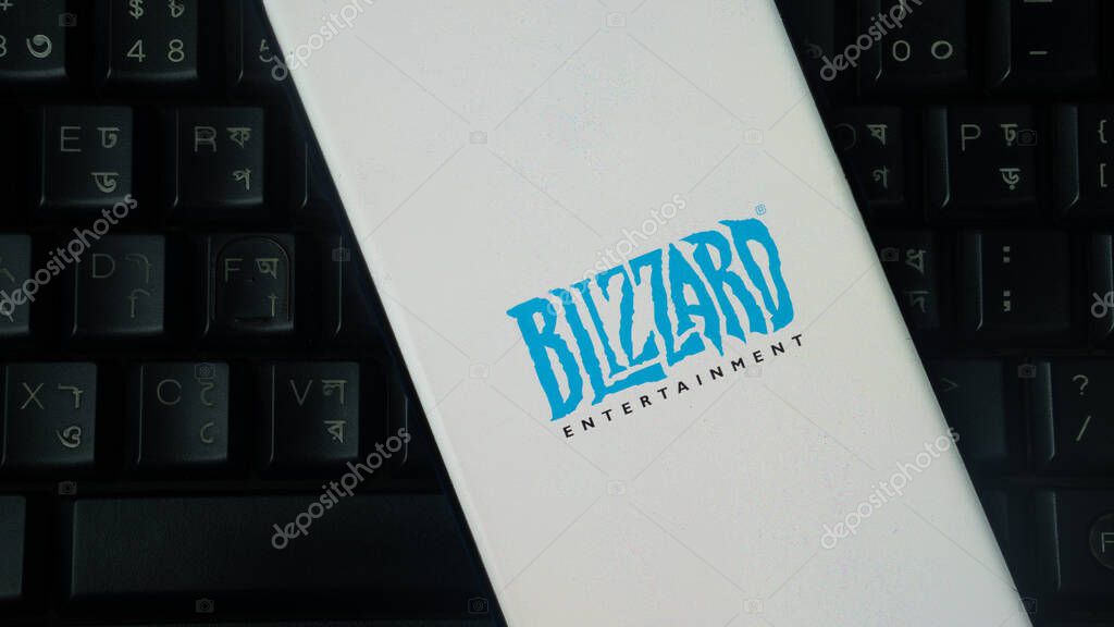 Dhaka, Bangladesh 02 June 2025:Smartphone featuring BLIZZARD ENTERTAINMENT logo on white screen over black keyboard.