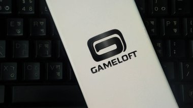 Dhaka, Bangladeş 04 Temmuz 2025: Siyah beyaz Gameloft logosu arka planda klavye ile sergileniyor