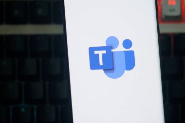 Dhaka, Bangladesh 23 August 2025:Microsoft Teams logo displayed on a smartphone screen against a dark keyboard background