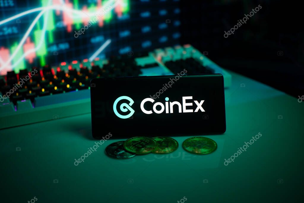 Dhaka, Bangladesh 18 September 2025:CoinEx logo displayed with coins on a desk and trading graphs in the background
