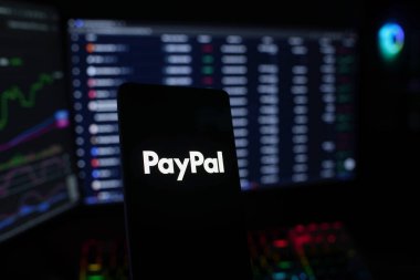 Dhaka, Bangladesh 18 September 2025:PayPal logo shown with coins and illuminated market analysis graph