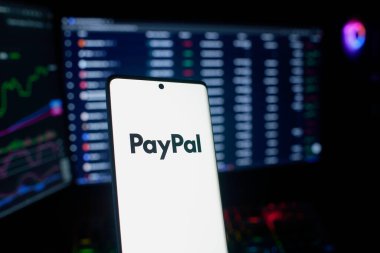 Dhaka, Bangladesh 18 September 2025:PayPal logo shown with coins and illuminated market analysis graph