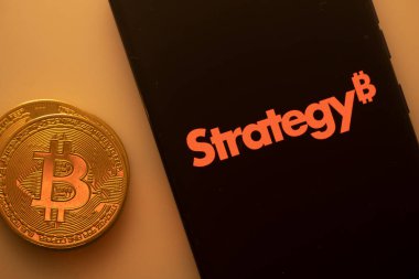 Dhaka, Bangladesh 22 September 2025:A Bitcoin coin next to a Strategy logo on a black background
