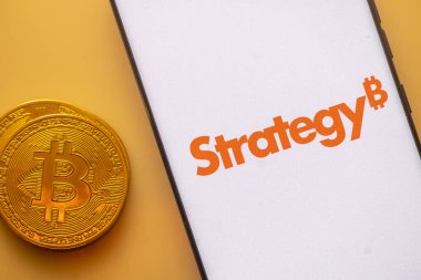 Dhaka, Bangladesh 22 September 2025:Phone shows Strategy logo with Bitcoin symbol and crypto coins on vivid screen