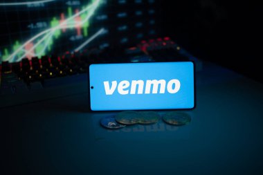Dhaka, Bangladesh 18 September 2025:Venmo app on phone screen with coins and stock chart in background