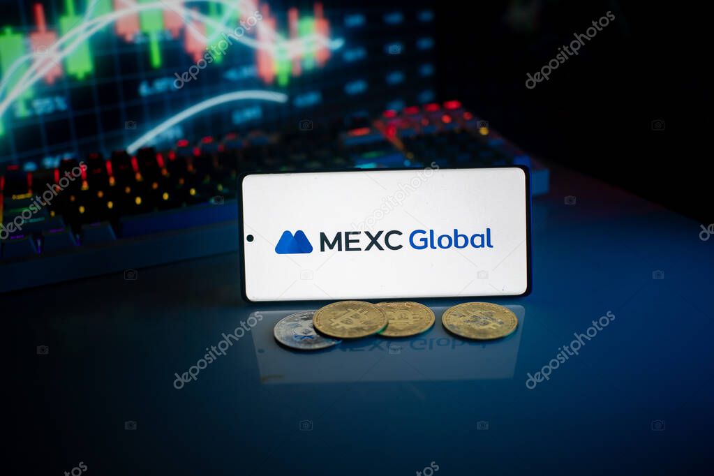Dhaka, Bangladesh 18 September 2025:Phone shows MEXC Global logo with crypto coins and trading screen illuminated