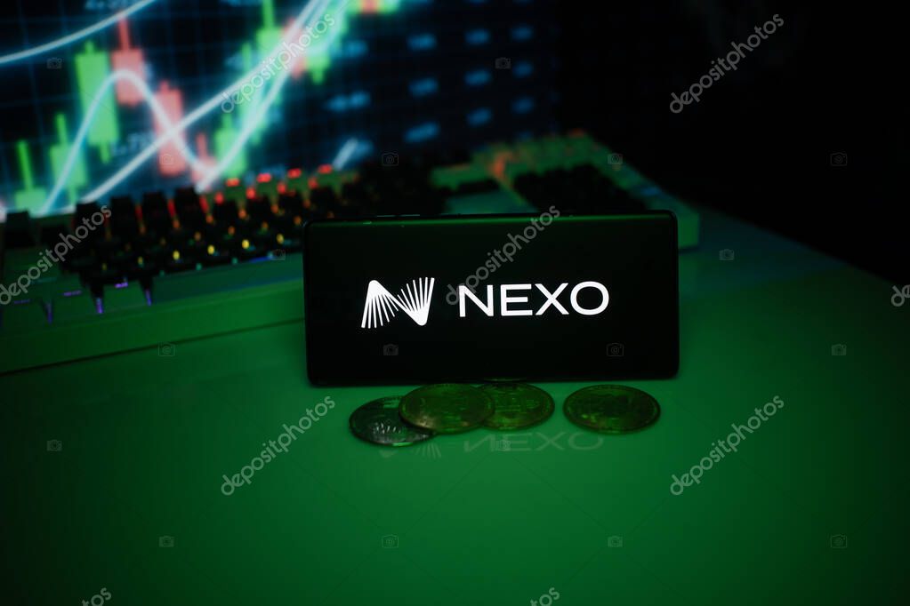 Dhaka, Bangladesh 18 September 2025: NEXO on a smartphone with currency tokens and fluctuating charts behind