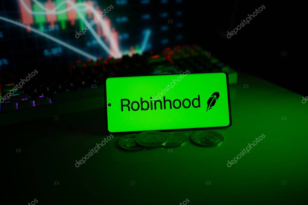 Dhaka, Bangladesh 18 September 2025:Robinhood logo on a phone with coins, set against a stock chart with green neon glow