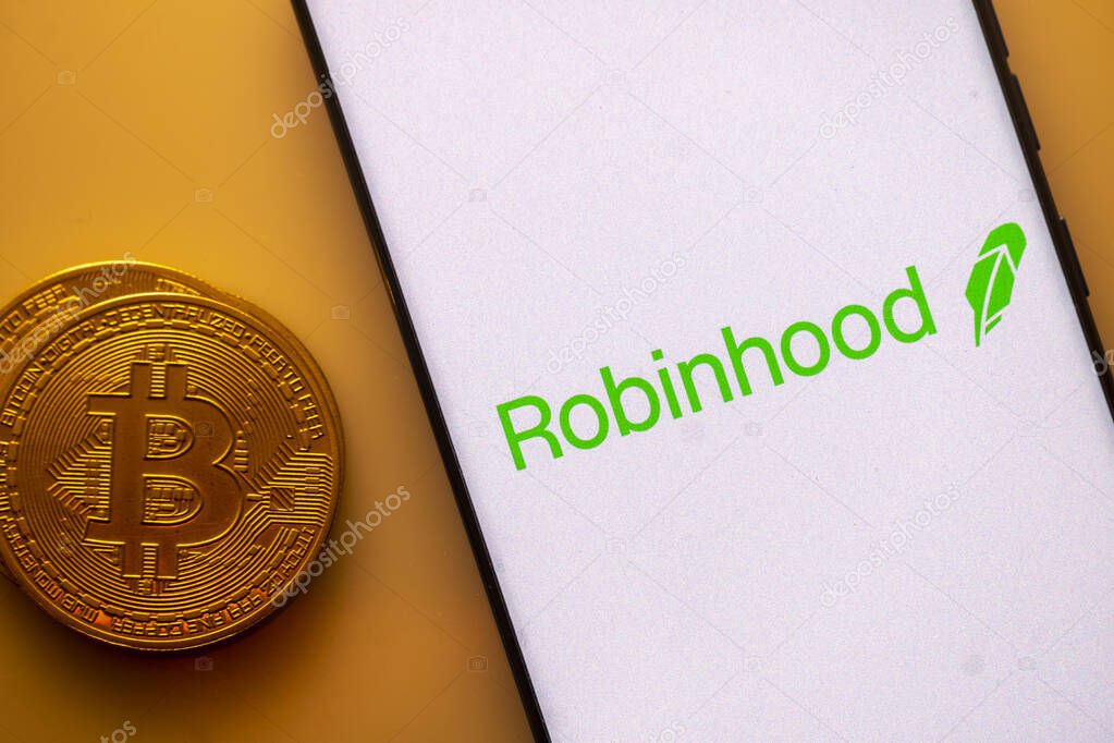 Dhaka, Bangladesh 22 September 2025:Robinhood logo displayed on a smartphone next to a Bitcoin coin