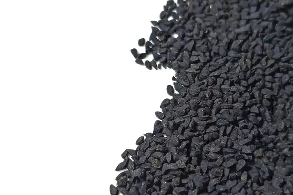 Black cumin seeds pile isolated on white background