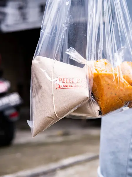 a take away pecel rice on a motorcycle