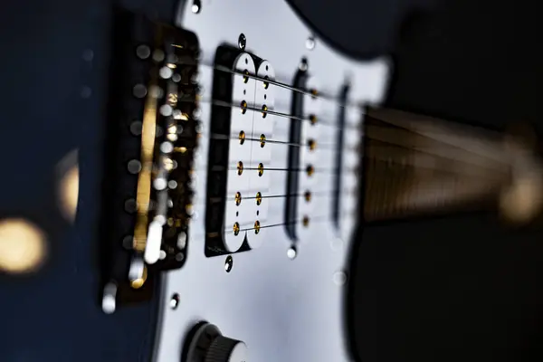 Blue electric guitar with reflections of stage spotlights in private concert