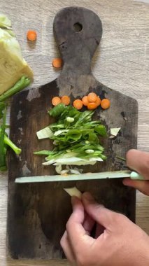 Mutfakta sebze kesme, tahta kesme, yemek pişirme, sebze kesme.