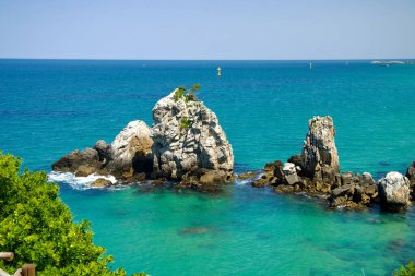 Donghae City, South Korea - May 18th, 2024: The striking formations of Brothers Rock rise from the clear turquoise waters of the East Sea near Chuam Beach. These iconic rocks symbolize brotherly love and are a well-known natural landmark. clipart