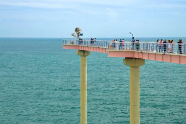 Uljin County, South Korea - July 27th, 2024: Tourists gather at the edge of the Deunggi Mountain Skywalk, enjoying expansive views of the East Sea and the surrounding coastal scenery. clipart