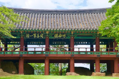 Samcheok, South Korea - July 29, 2024: A detailed close-up of the Jukseoru Pavilion's intricate wooden beams and traditional Korean roof, highlighting the craftsmanship of this historic landmark surrounded by greenery. clipart