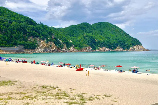 Yonghwa Plajı, Samcheok, Kore, plaj, kum, dağlar, rahatlama, şemsiyeler, okyanus, deniz, turkuaz suyu, yaz, seyahat, doğa, macera, manzara, açık hava, turizm, aile dostu, barışçıl, plaja gidenler, manzara, kıyı, Güney Kore, tatil, 