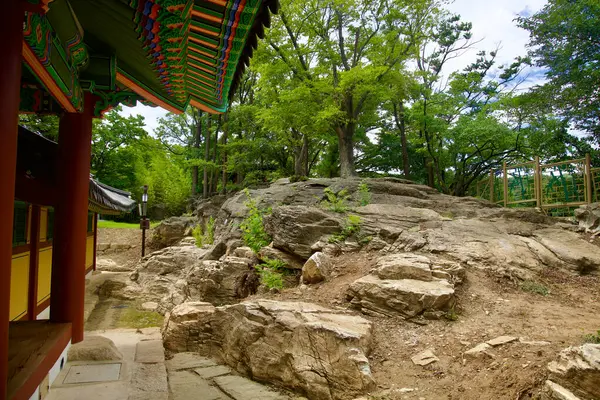 stock image Samcheok, South Korea - July 29, 2024: A view of the natural rocky terrain surrounding the Jukseoru Pavilion, blending traditional Korean architecture with the rugged landscape and lush trees of Gangwon Province.