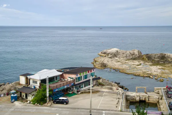 stock image Sokcho City, South Korea - July 28th, 2024: A charming seaside restaurant located near the Sokcho Lighthouse and Yeonggeum Pavilions, offering visitors a place to enjoy local cuisine with views of the rocky coastline and the East Sea.