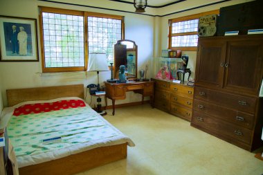 Goseong County, South Korea - July 28th, 2024: A recreated scene of Syngman Rhee's bedroom inside an auxiliary building near his historic cottage, featuring period furniture, a bed, and personal items, providing a glimpse into the life of South Korea clipart