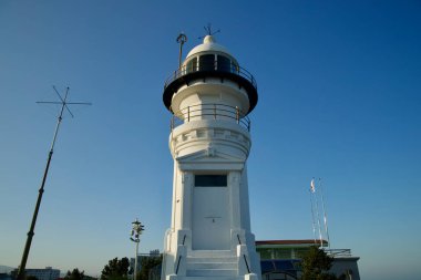 Gangneung City, South Korea - November 3rd, 2024: A detailed frontal view of Jumunjin Lighthouse, highlighting its architectural features under a clear blue sky, symbolizing Korea's rich maritime history. clipart