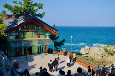 Yangyang County, South Korea - November 3rd, 2024: Avalokitesvara Hall at Huyuam Hermitage, beautifully perched near the rocky coastline, offering stunning views of the East Sea and traditional architecture. clipart