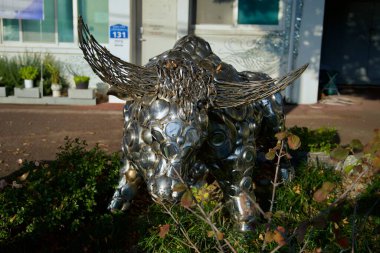 Ulsan, South Korea - November 14, 2024: A striking metal bull sculpture made from recycled materials stands prominently outside a restaurant near Jangsaengpo, showcasing creative artistry. clipart