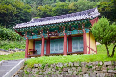 Goesan County, South Korea - September 10th, 2020: The Chilchung Temple's main shrine, a beautifully preserved Joseon-era structure dedicated to the Seven Loyalists, featuring traditional dancheong-painted eaves and wooden pillars. clipart