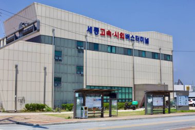 Sejong City, South Korea - May 26, 2021: A view of Sejong Intercity Bus Terminal with adjacent bus stops on a sunny afternoon. The terminal serves as a transportation hub connecting various cities across Korea. clipart