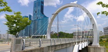 Sejong City, South Korea - May 26, 2021: A view of Naseong 4th Bridge, a modern cable-stayed structure, with the futuristic skyline of downtown Sejong City in the background. clipart