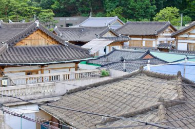 Gongju, South Korea - May 27, 2021: A scenic view of traditional hanok rooftops in Gongju, featuring curved tiled roofs and wooden structures, blending heritage architecture with modern additions. clipart