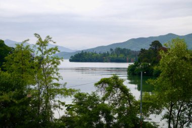 Namyangju, South Korea - May 19th 2025: A peaceful view of Dumulmeori, where the North and South Han Rivers join, framed by forested hills and calm reflective waters near Yangpyeong.
