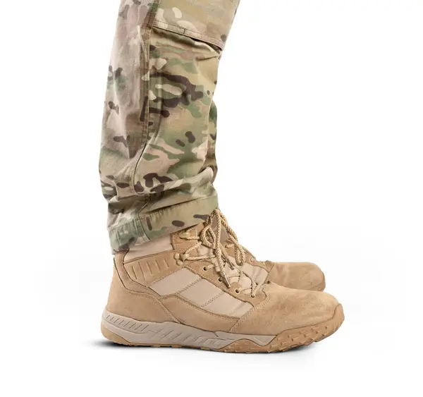 Soldier in military boots on a white background close-up. Army boots.