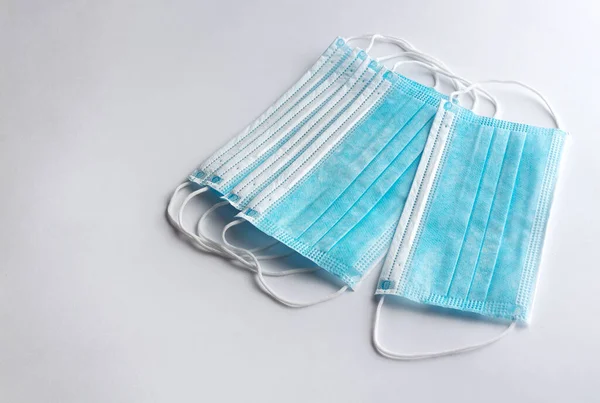 Set of surgical masks with rubber ear straps for protection against influenza and viruses on white background.