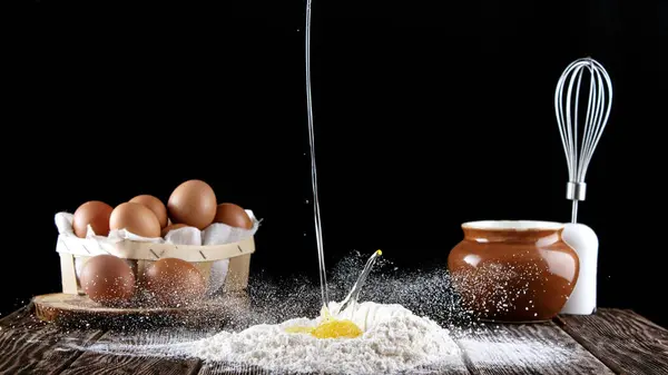 밀가루에 떨어지는 계란의 밀가루는 질감이있는 부어집니다 배경에는 위스키 냄비가있는 상자가 — 스톡 사진