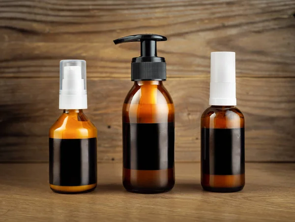 Dark Cosmetic Amber Glass Bottles Set Black Blank Labels Cosmetics — Stock Photo, Image