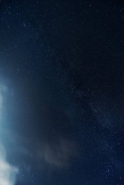 Gece yıldızlı gökyüzü ay ışığıyla aydınlanan bulutlarla. Gece manzarası. Astrofotoğrafçılık.