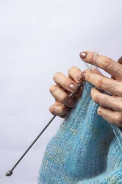 Örgü ören ellerin yakın çekimi. Örgü örme süreci. El yapımı..