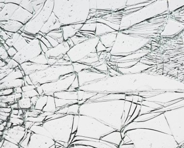 Glass with cracks. Broken window texture on white background. clipart