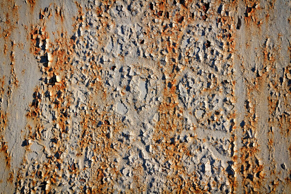Texture of peeling paint on a rusty metal surface.