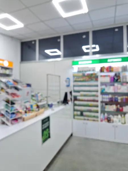 Blurred view inside a pharmacy. Healthcare and cosmetics industry defocused vertical background