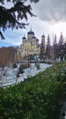 Hancu Monastery outdoors winter view. Traditional Christian Orthodox church located in the middle of the snowy woods in Republic of Moldova. Eastern Europe basilica traditional architecture style