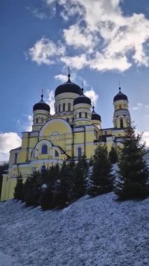 Hancu Monastery outdoors winter view. Traditional Christian Orthodox church located in the middle of the snowy woods in Republic of Moldova. Eastern Europe basilica traditional architecture style